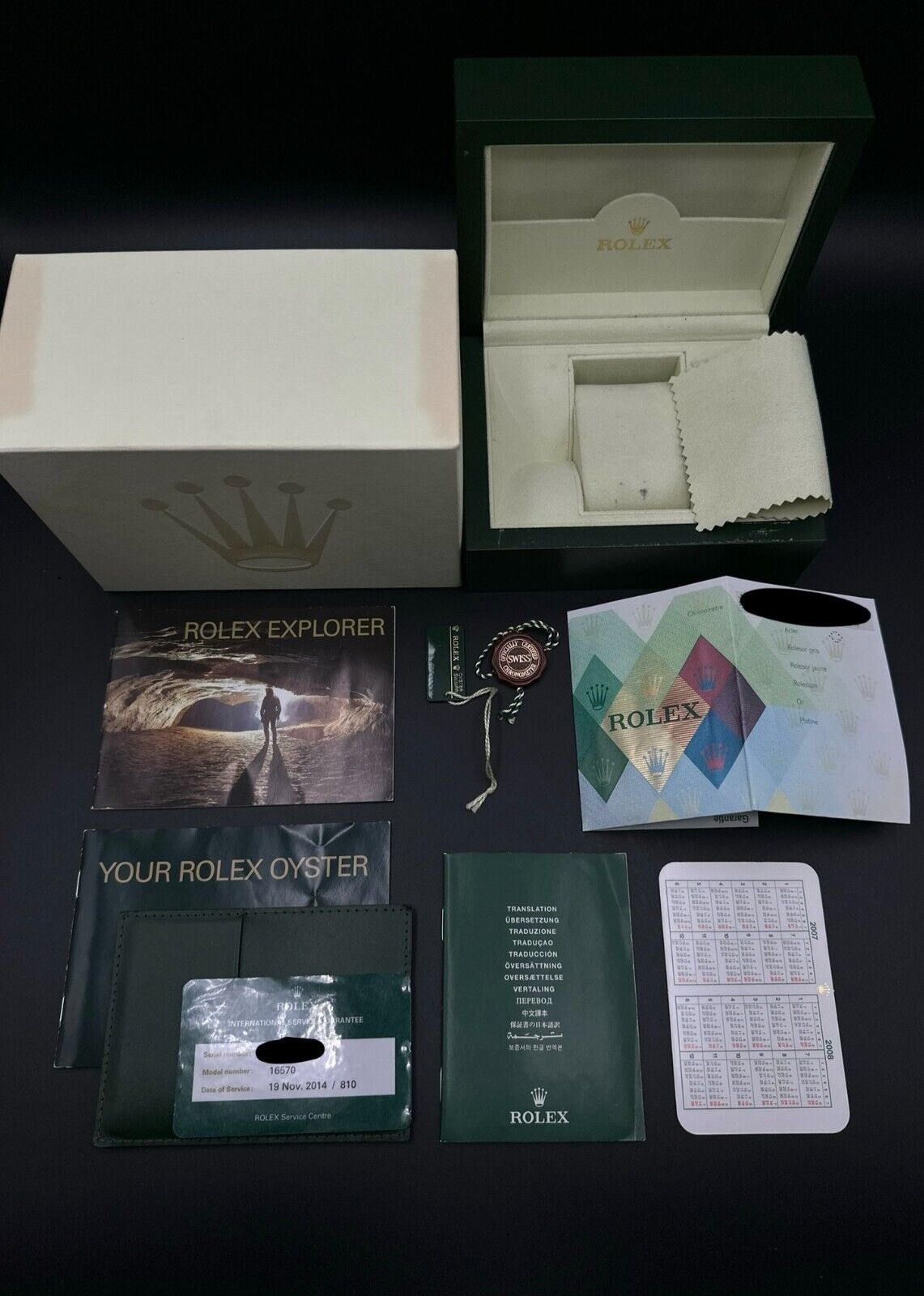 Rolex Explorer II 16570 Black Dial 40mm Watch, 2008 model, featuring a stainless steel case, black dial, and 24-hour fixed bezel. Comes with a stainless steel Rolex Oyster bracelet. Very good condition with minimal signs of wear. Includes inner and outer boxes, warranty papers, Rolex 2007-2008 calendar, Explorer II booklet, Oyster booklet, red hang tag, serial hang tag, Rolex Service warranty card, official chronometer booklet, and leather card holder. Available at The Watch Trader, Madison, Connecticut.