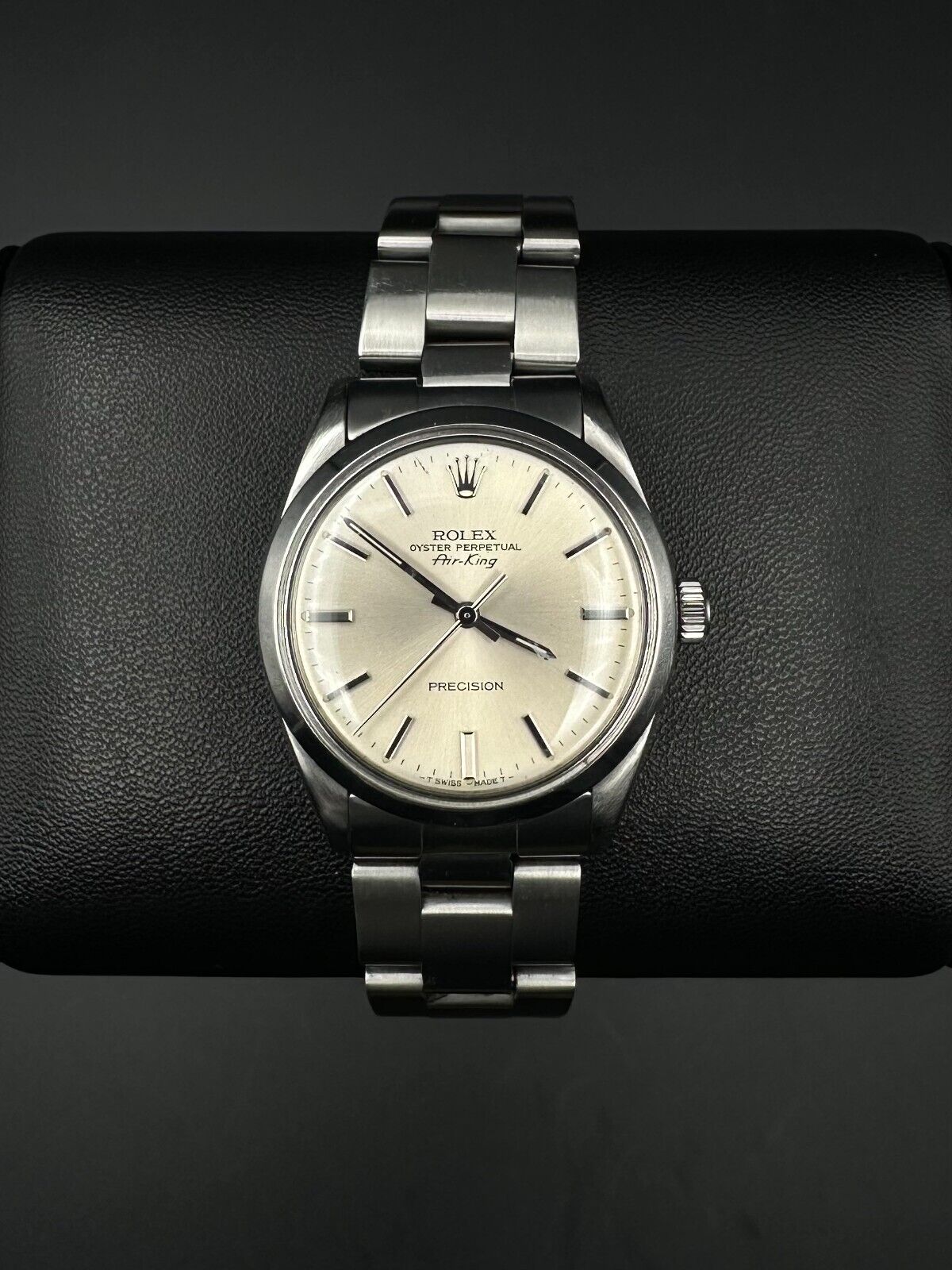 Rolex Air-King 5500, 1987 model, featuring a 34mm stainless steel case, silver dial, and stainless steel Rolex Oyster bracelet. Fair condition with noticeable signs of wear. Includes warranty papers and service certificate. Available at The Watch Trader, Madison, Connecticut.