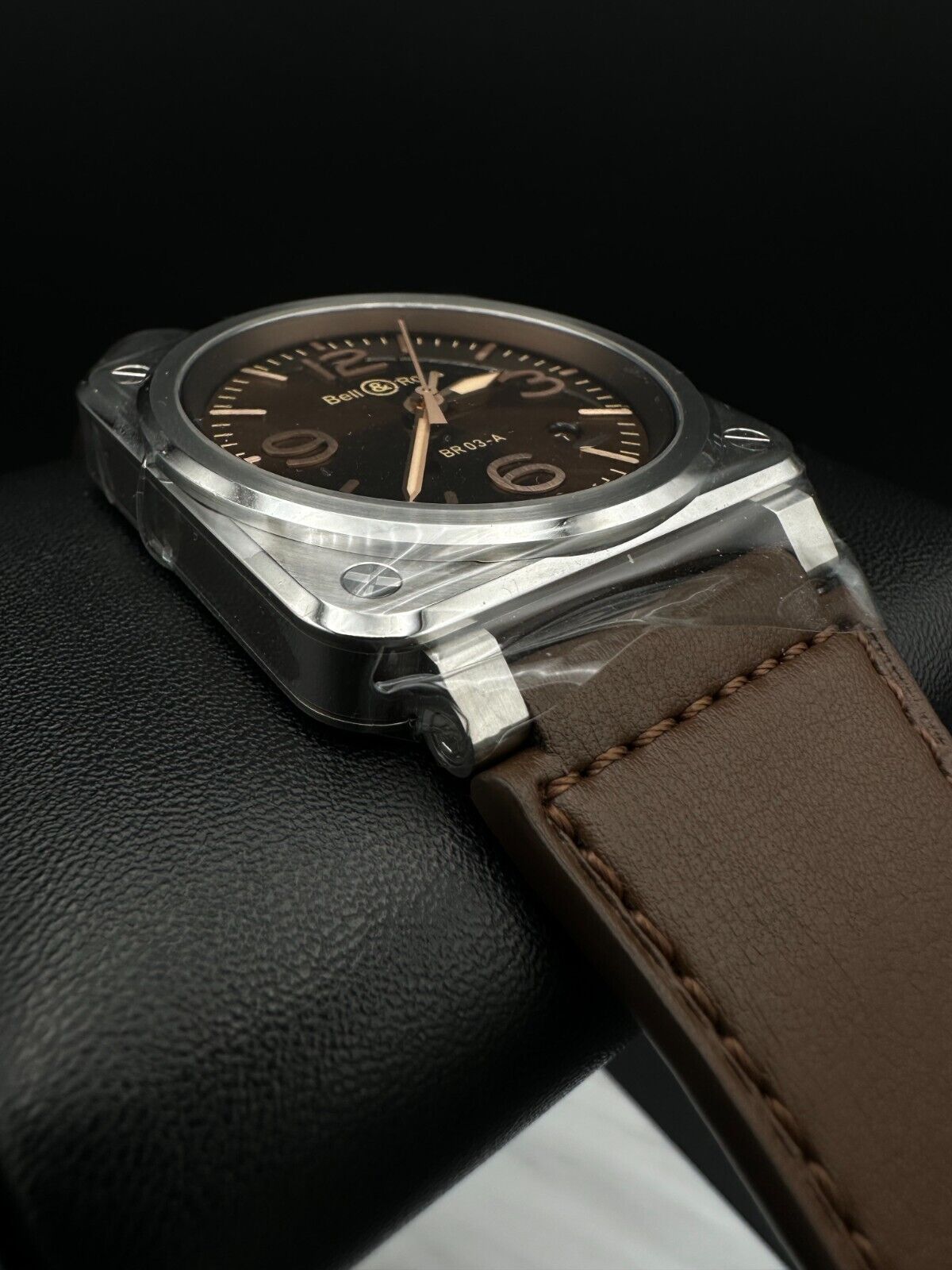 Bell & Ross BR-03 Golden Heritage 41mm men's watch featuring a striking brown sunray dial with gilt appliqué numerals and indices, metal skeletonized Super-LumiNova®-filled hands, and a smooth stainless steel bezel. The stainless steel case houses a 41mm diameter and is complemented by a brown calfskin leather strap. Brand new condition with original box, warranty card, user guide, and additional black canvas strap included. Available at The Watch Trader in Madison, Connecticut.