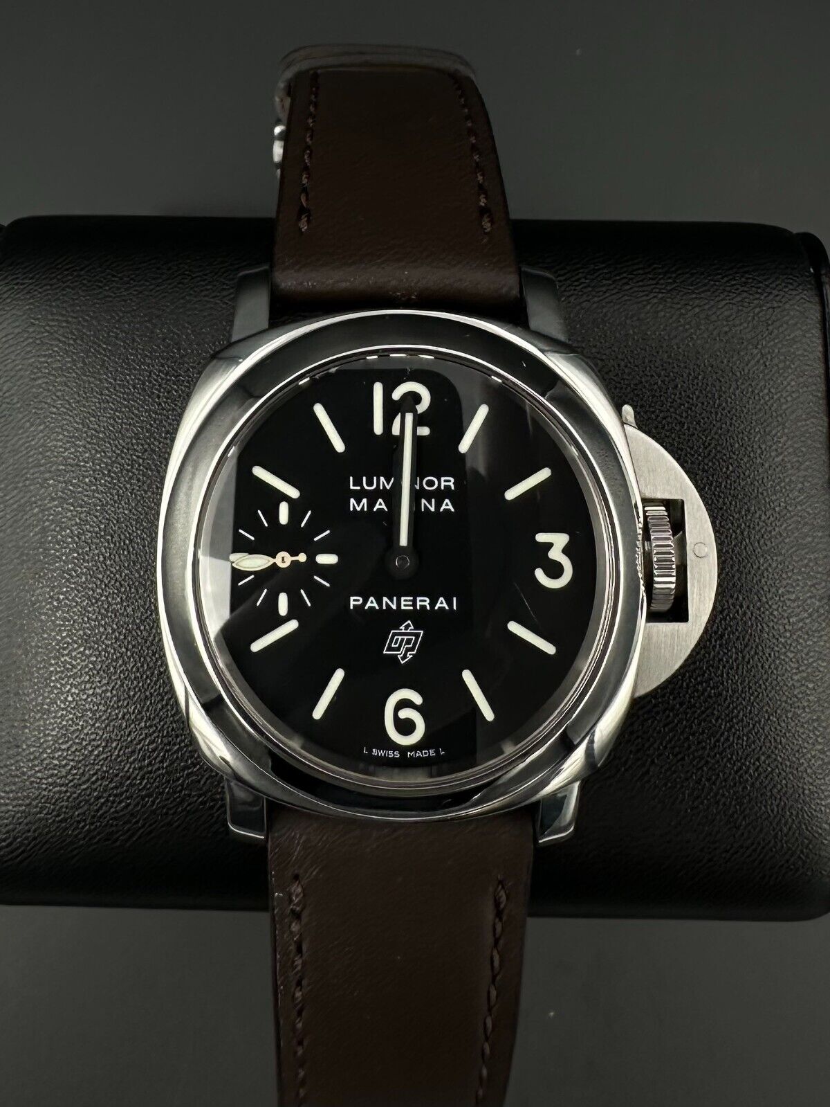 Panerai Luminor Marina PAM001 men's watch, featuring a 44mm stainless steel case and bold black dial. This iconic timepiece combines Panerai's renowned design with exceptional durability, making it ideal for collectors seeking a reliable and stylish luxury watch. Available from The Watch Trader in Madison, Connecticut.