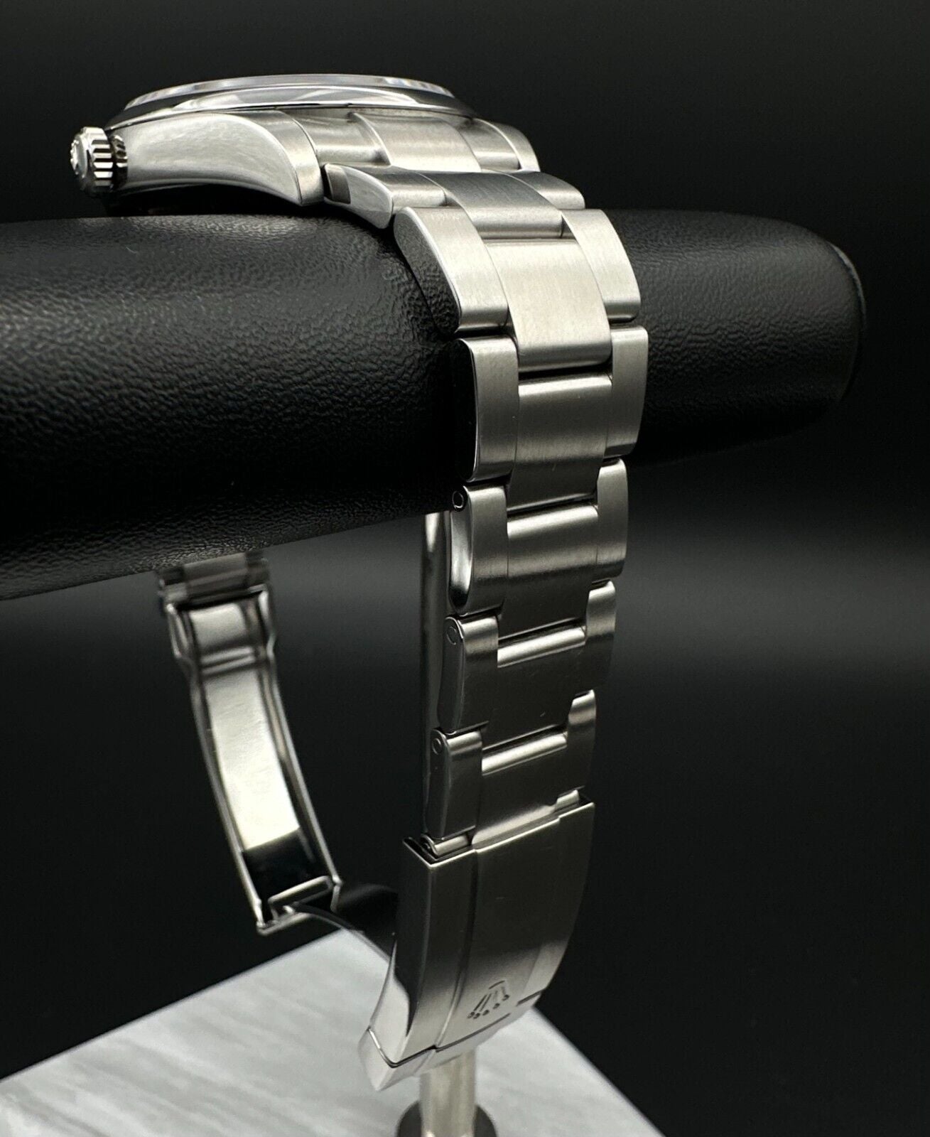 Rolex Oyster Perpetual 39mm watch, model 114300, featuring a sleek rhodium dial and durable steel oyster bracelet, 2019 release. This elegant timepiece combines modern aesthetics with Rolex's signature craftsmanship, ideal for those seeking a versatile luxury watch. Available from The Watch Trader CT.