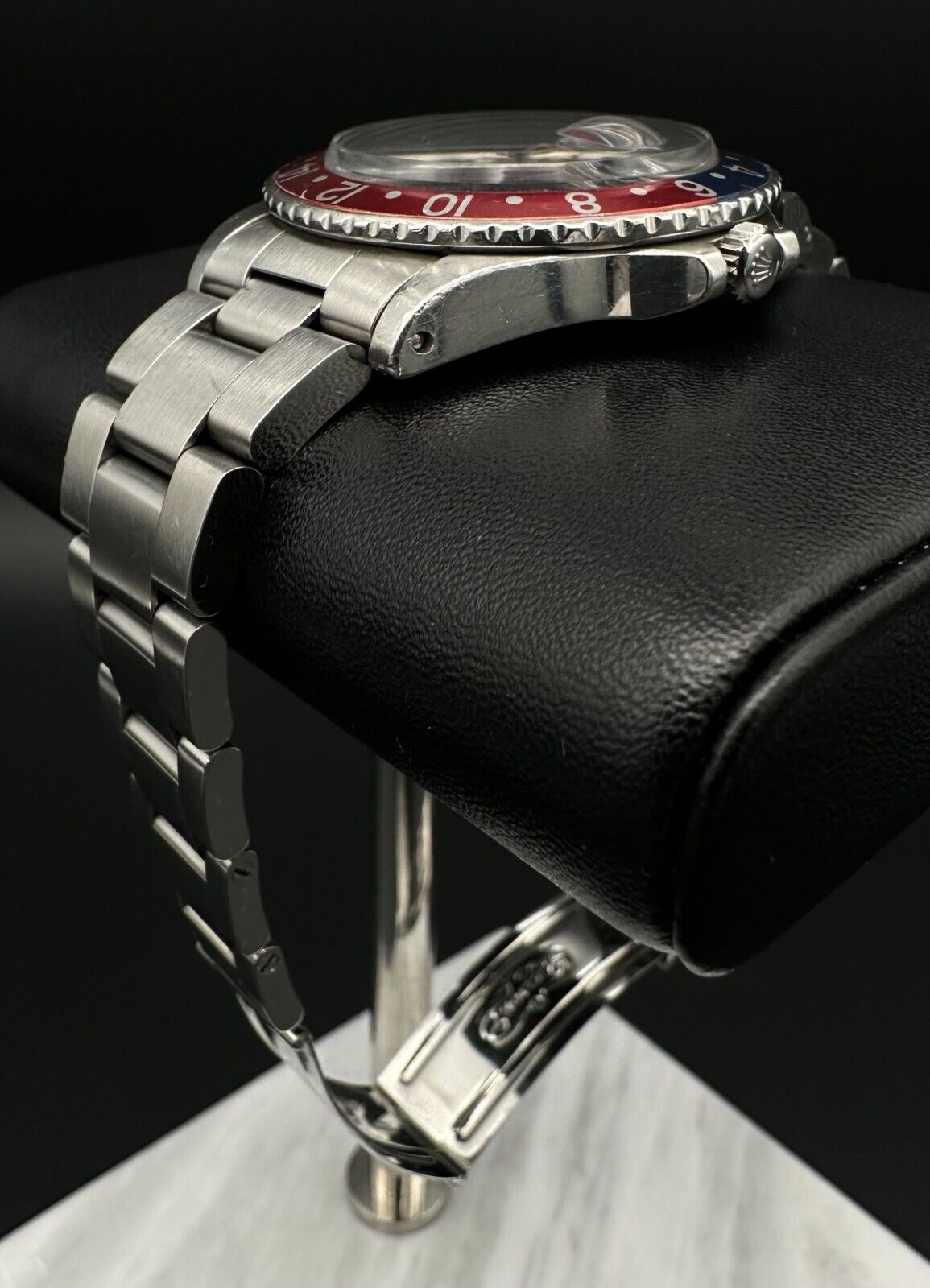 Rolex GMT-Master 1675 automatic watch, featuring the iconic 'Pepsi' bezel and stainless steel oyster bracelet, from 1972. This vintage 40mm timepiece combines classic design with dual-timezone functionality, making it ideal for collectors and enthusiasts of historical luxury watches. Available from The Watch Trader CT.