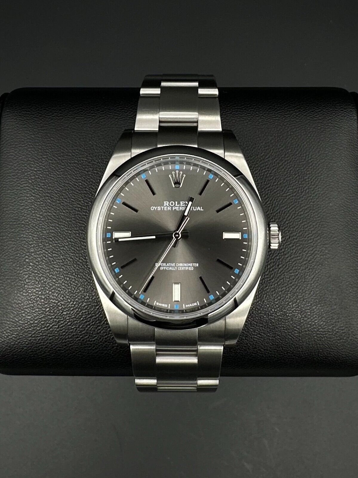 Rolex Oyster Perpetual 39mm watch, model 114300, featuring a sleek rhodium dial and durable steel oyster bracelet, 2019 release. This elegant timepiece combines modern aesthetics with Rolex's signature craftsmanship, ideal for those seeking a versatile luxury watch. Available from The Watch Trader CT.