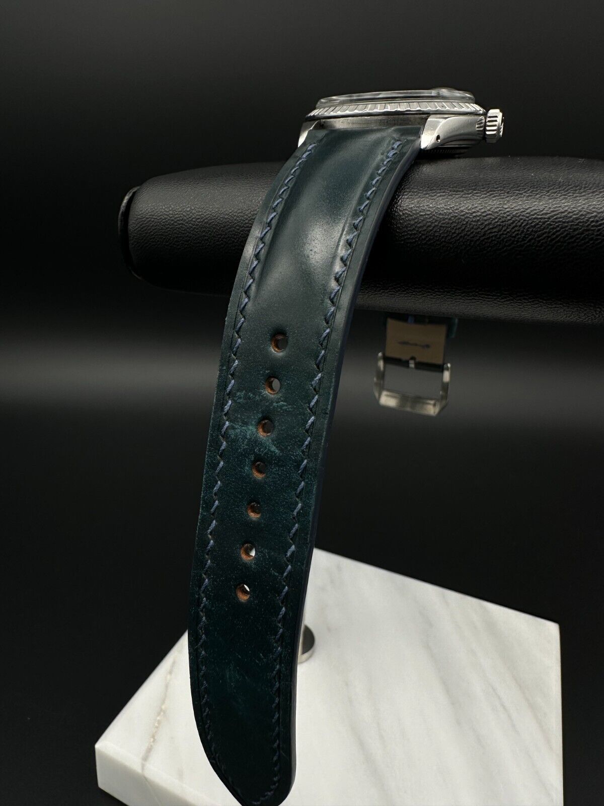Rolex Datejust 36mm automatic watch, model 1603, featuring a blue dial and distinctive engine-turned bezel, from 1975. This vintage timepiece offers a blend of timeless design and enduring craftsmanship, ideal for collectors and enthusiasts of classic Rolex watches. Available from The Watch Trader in Madison, Connecticut.