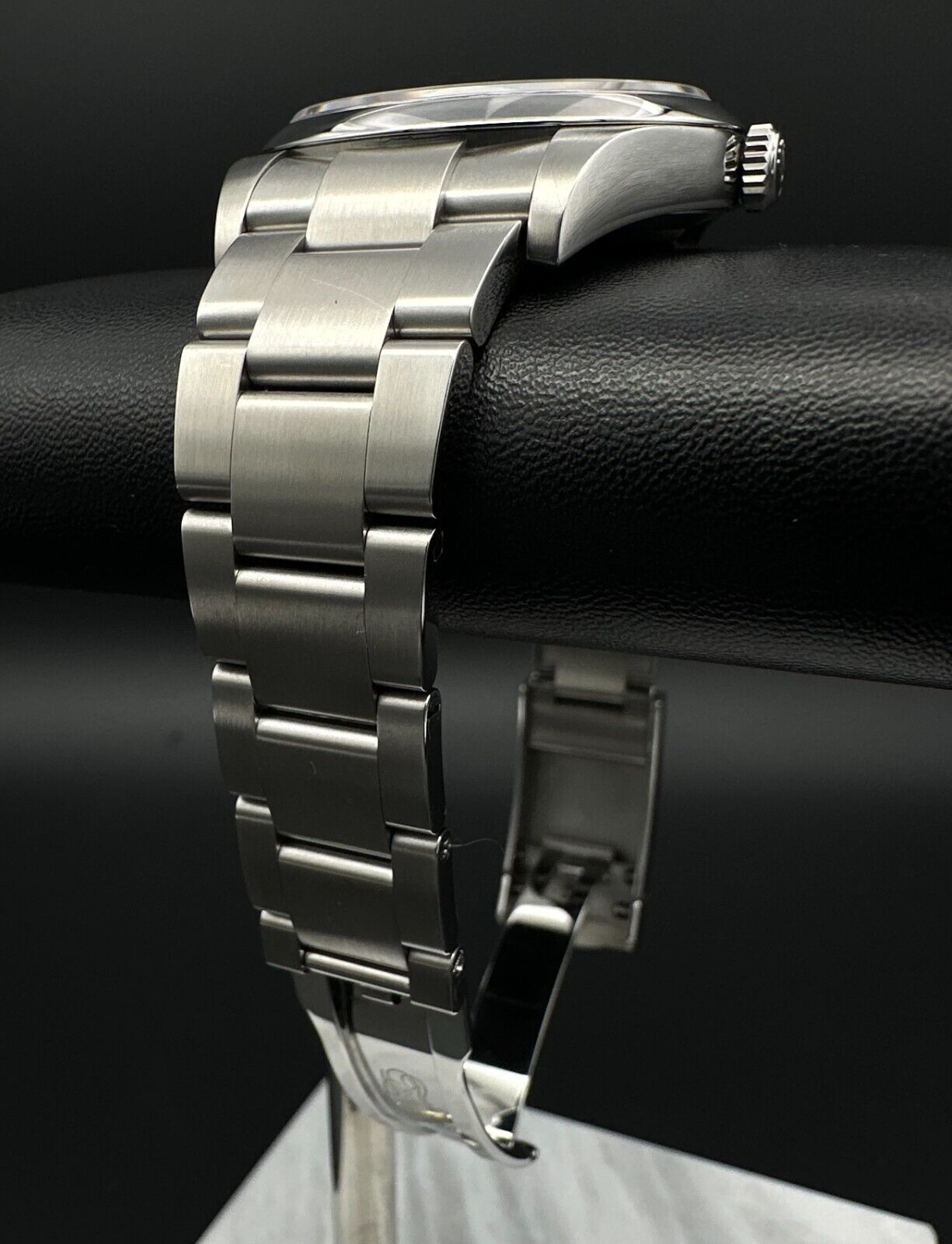 Rolex Oyster Perpetual 39mm watch, model 114300, featuring a sleek rhodium dial and durable steel oyster bracelet, 2019 release. This elegant timepiece combines modern aesthetics with Rolex's signature craftsmanship, ideal for those seeking a versatile luxury watch. Available from The Watch Trader CT.