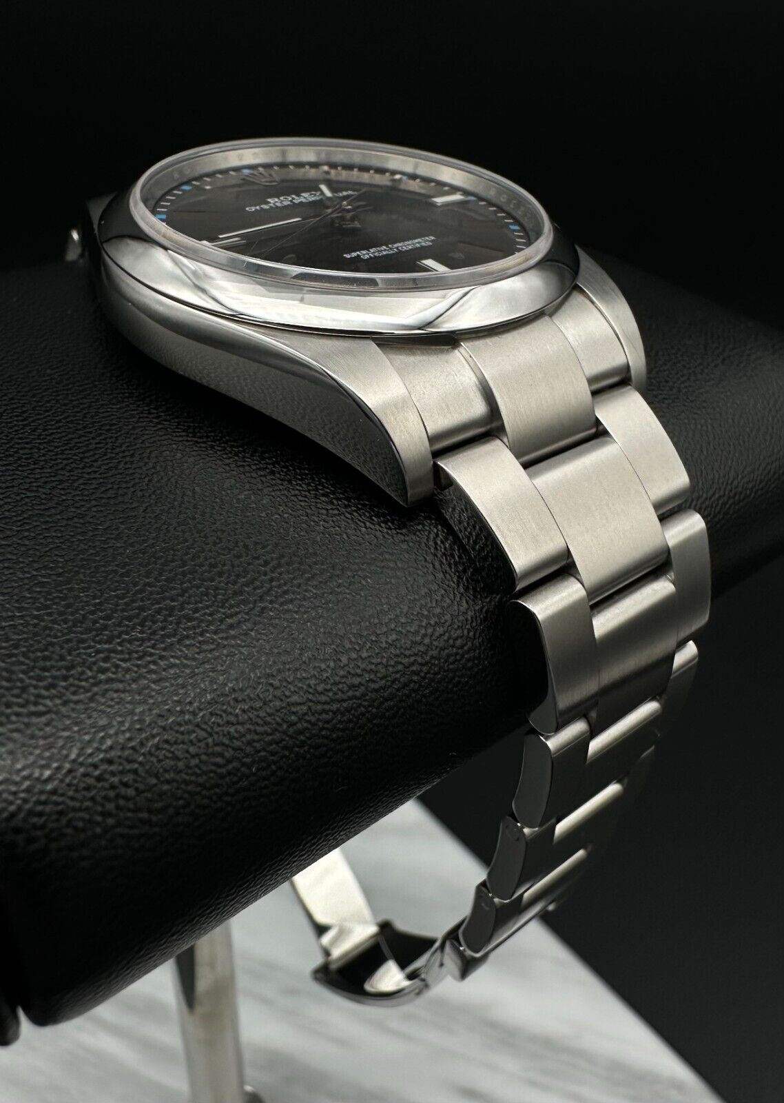 Rolex Oyster Perpetual 39mm watch, model 114300, featuring a sleek rhodium dial and durable steel oyster bracelet, 2019 release. This elegant timepiece combines modern aesthetics with Rolex's signature craftsmanship, ideal for those seeking a versatile luxury watch. Available from The Watch Trader CT.