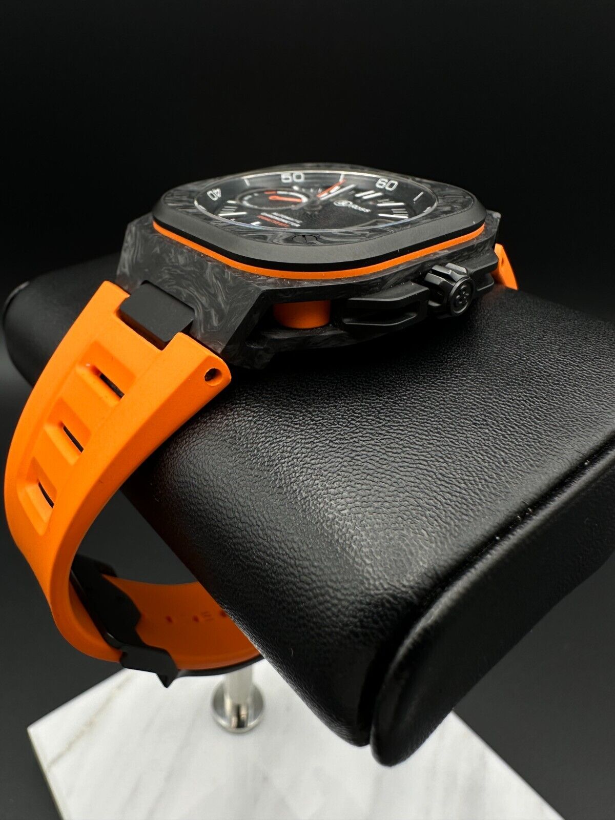 Bell & Ross Limited Edition BR-X5 Carbon Orange BRX5R-BO-TC/SRB, 2023 model, featuring a 41mm Grade 2 microblasted titanium case with DLC finish, matte black dial, and orange rubber strap with folding buckle. The dial has applique indices filled with Super-LumiNova® and skeletonized metal hands. The fixed bezel is made of Grade 2 microblasted titanium with a matt carbon fiber insert. Very good condition with minimal signs of wear. Limited edition of 500 pieces. Includes inner and outer boxes, warranty card,