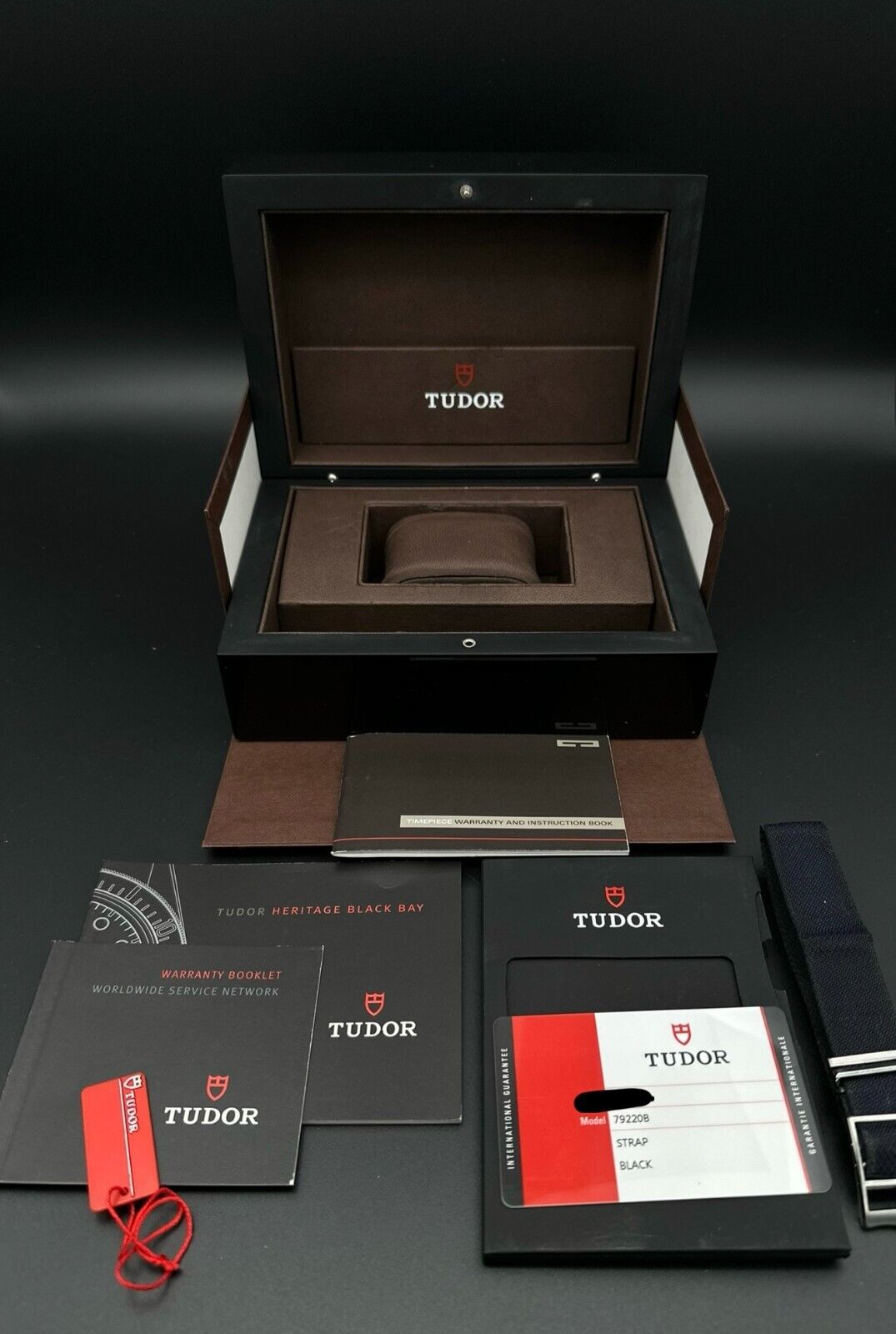 Tudor Heritage Black Bay men's automatic watch, model 79220B, with distinctive black 'Smiley' dial and 2014 release. Features a classic 41mm stainless steel case and vintage-inspired design, ideal for collectors of iconic timepieces. Available from The Watch Trader CT.