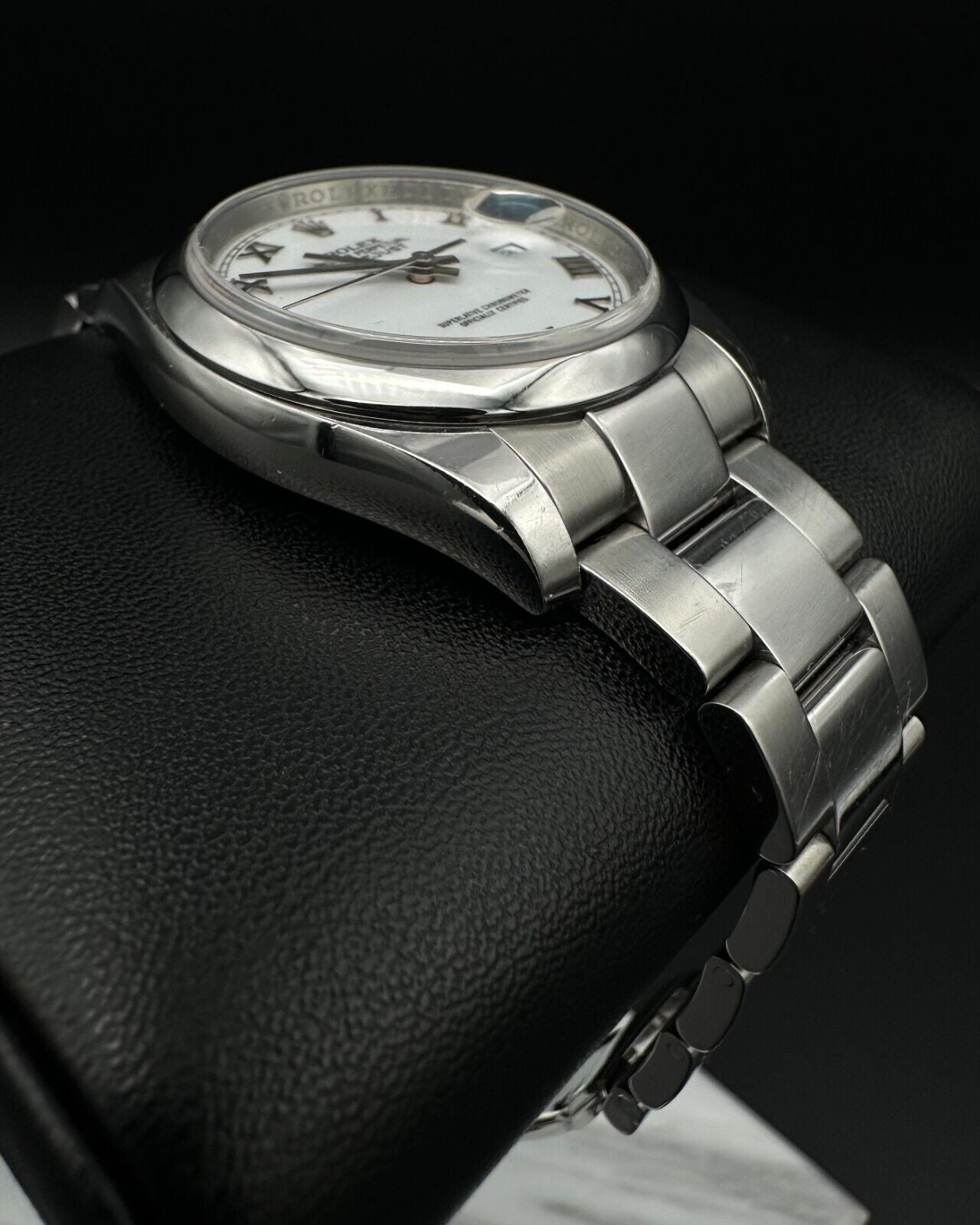 Rolex Datejust 36mm watch, model 116200, featuring a white Roman numeral dial and stainless steel Oyster bracelet. This classic automatic timepiece embodies refined elegance and versatility, perfect for collectors and enthusiasts seeking a timeless luxury watch. Available from The Watch Trader in Madison, Connecticut.
