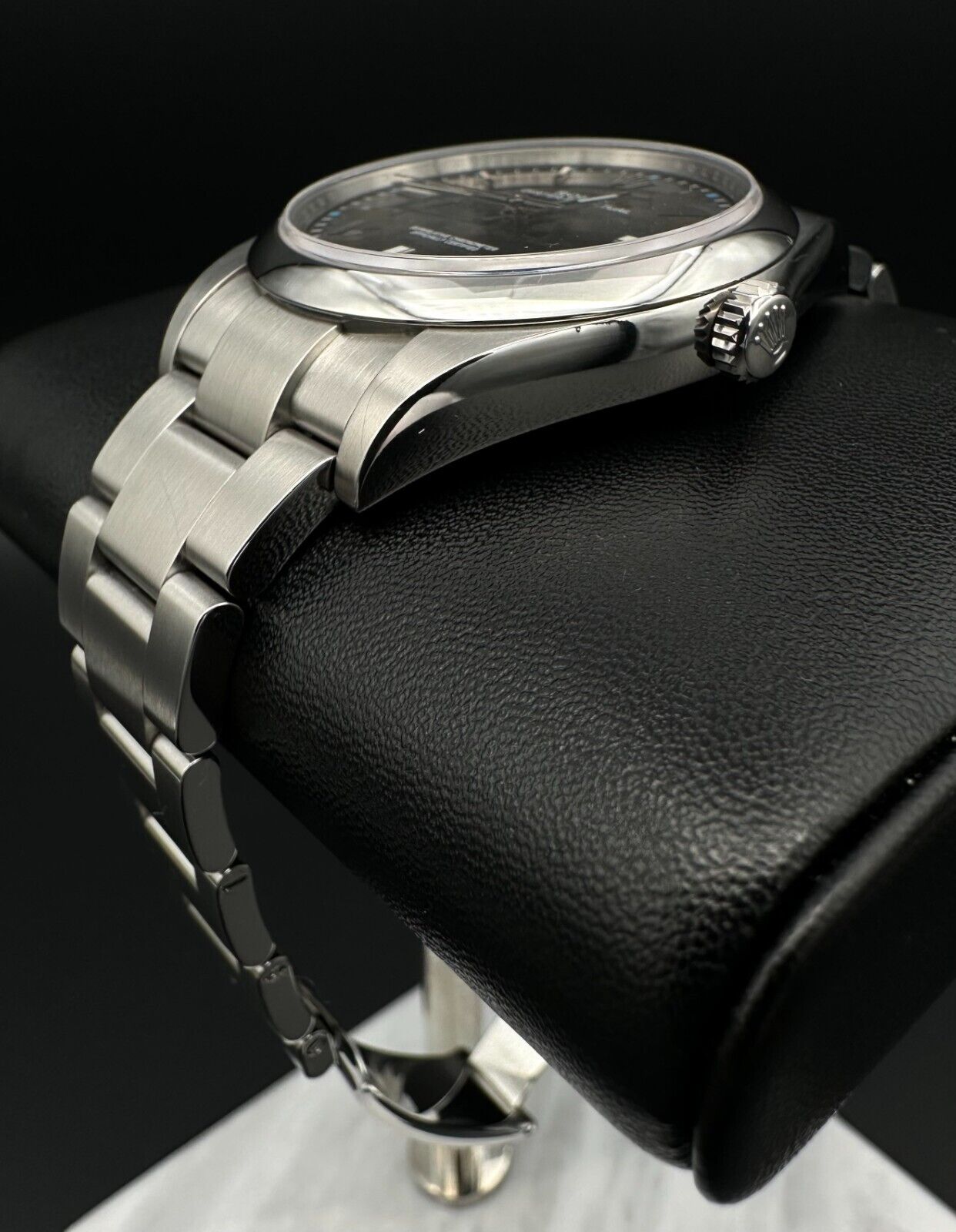 Rolex Oyster Perpetual 39mm watch, model 114300, featuring a sleek rhodium dial and durable steel oyster bracelet, 2019 release. This elegant timepiece combines modern aesthetics with Rolex's signature craftsmanship, ideal for those seeking a versatile luxury watch. Available from The Watch Trader CT.