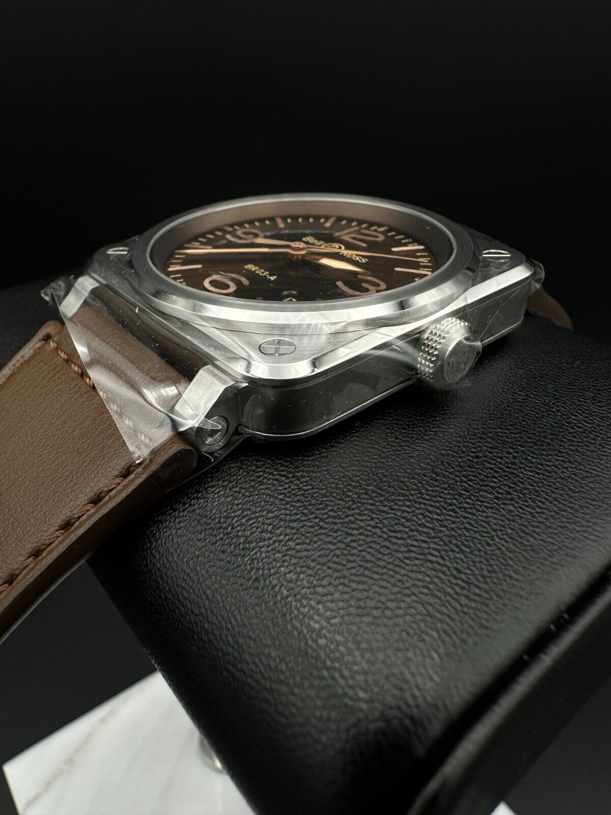 Bell & Ross BR-03 Golden Heritage 41mm men's watch featuring a striking brown sunray dial with gilt appliqué numerals and indices, metal skeletonized Super-LumiNova®-filled hands, and a smooth stainless steel bezel. The stainless steel case houses a 41mm diameter and is complemented by a brown calfskin leather strap. Brand new condition with original box, warranty card, user guide, and additional black canvas strap included. Available at The Watch Trader in Madison, Connecticut.
