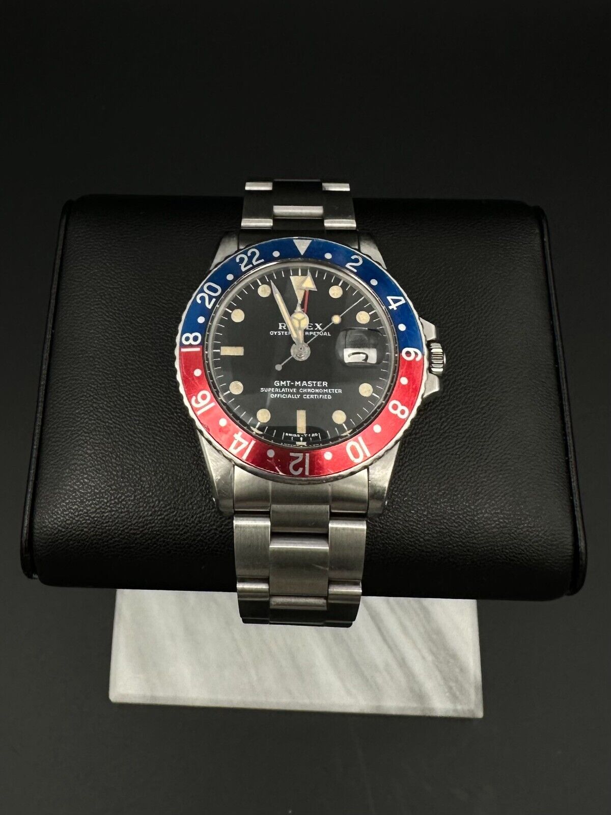 Rolex GMT-Master 1675 automatic watch, featuring the iconic 'Pepsi' bezel and stainless steel oyster bracelet, from 1972. This vintage 40mm timepiece combines classic design with dual-timezone functionality, making it ideal for collectors and enthusiasts of historical luxury watches. Available from The Watch Trader CT.