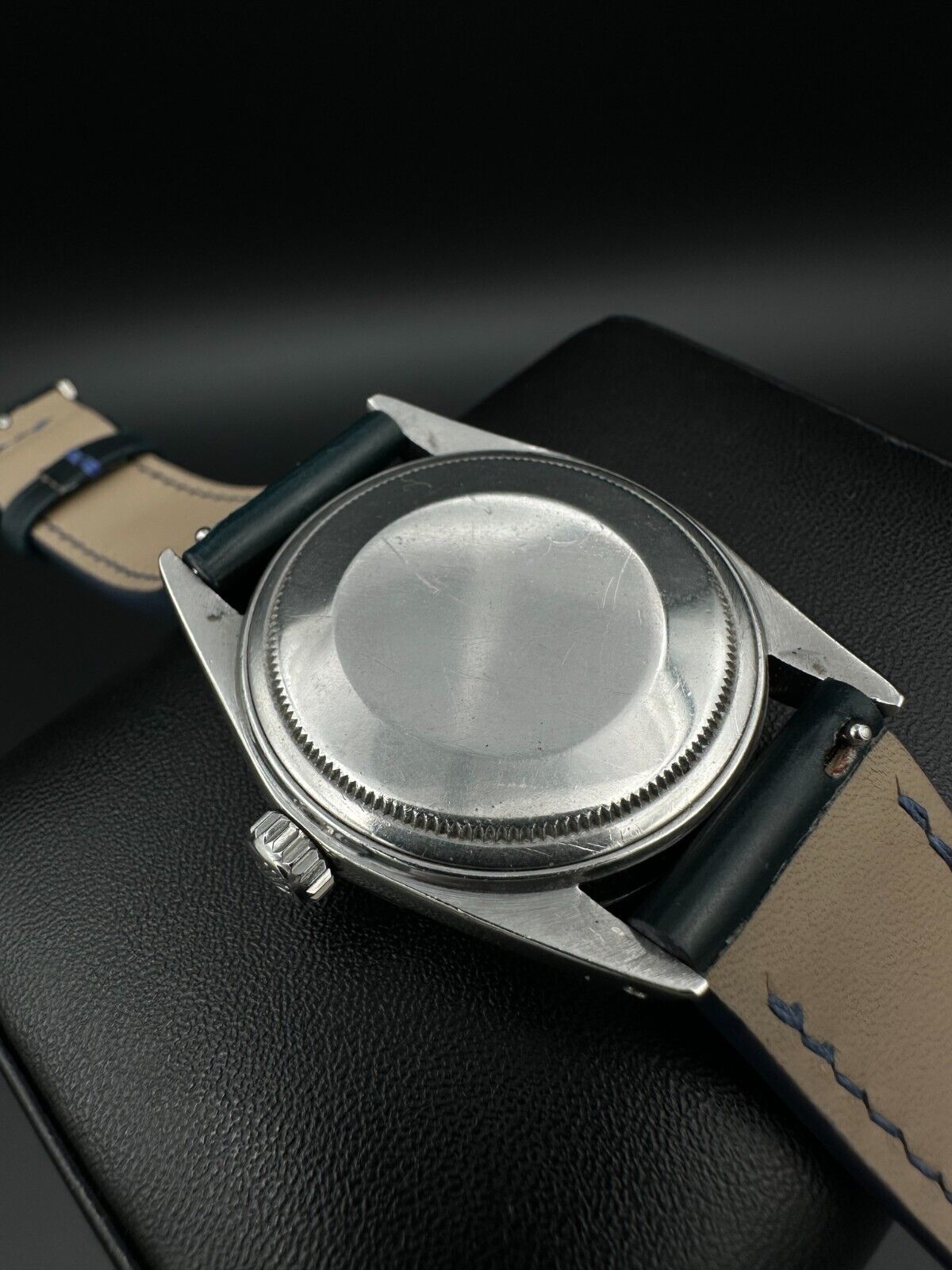 Rolex Datejust 36mm automatic watch, model 1603, featuring a blue dial and distinctive engine-turned bezel, from 1975. This vintage timepiece offers a blend of timeless design and enduring craftsmanship, ideal for collectors and enthusiasts of classic Rolex watches. Available from The Watch Trader in Madison, Connecticut.