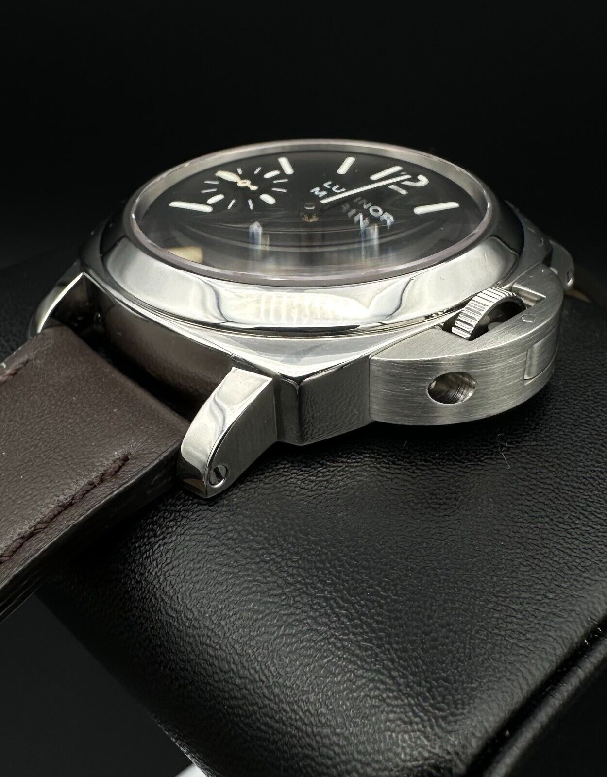 Panerai Luminor Marina PAM001 men's watch, featuring a 44mm stainless steel case and bold black dial. This iconic timepiece combines Panerai's renowned design with exceptional durability, making it ideal for collectors seeking a reliable and stylish luxury watch. Available from The Watch Trader in Madison, Connecticut.