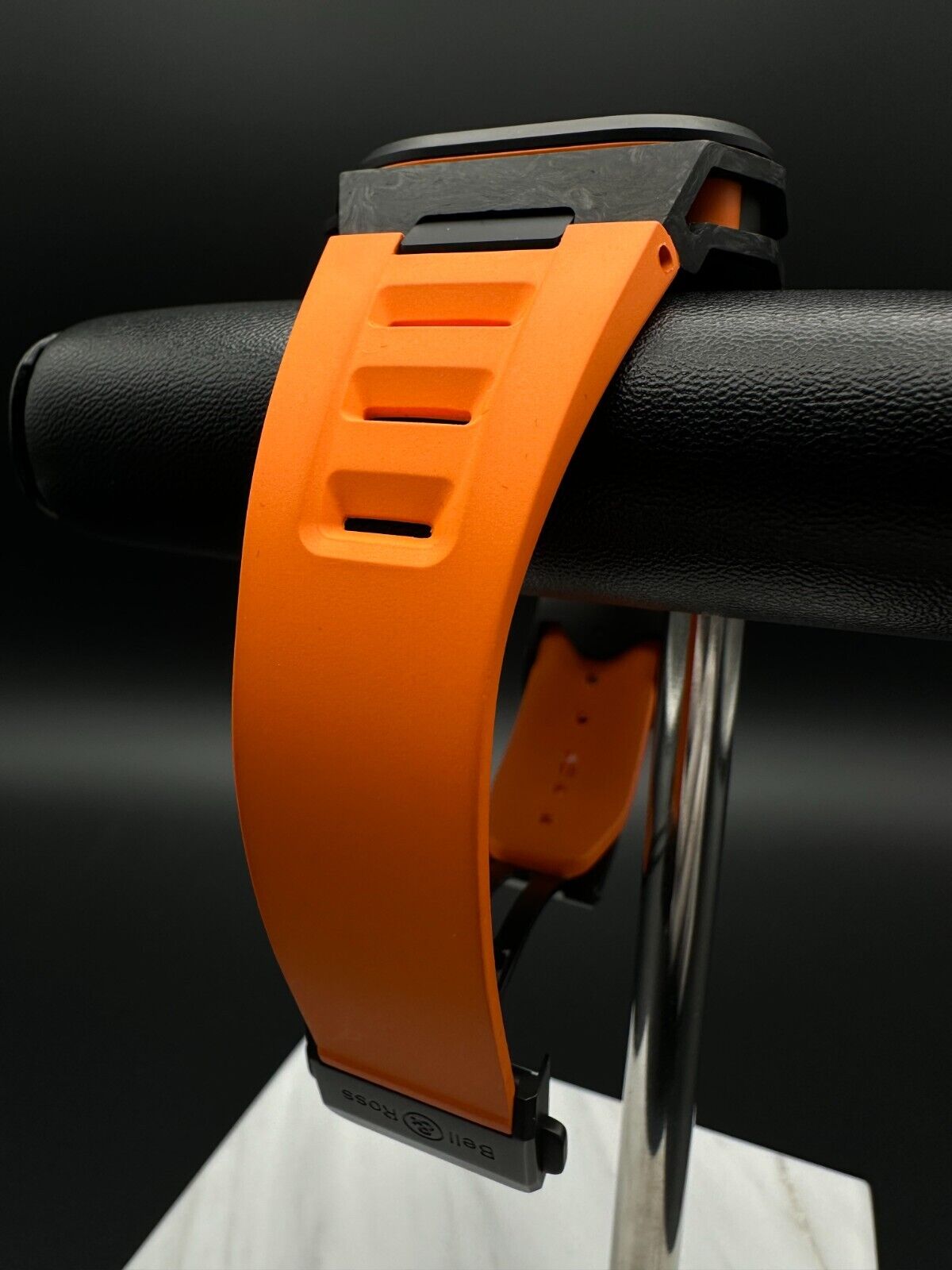 Bell & Ross Limited Edition BR-X5 Carbon Orange BRX5R-BO-TC/SRB, 2023 model, featuring a 41mm Grade 2 microblasted titanium case with DLC finish, matte black dial, and orange rubber strap with folding buckle. The dial has applique indices filled with Super-LumiNova® and skeletonized metal hands. The fixed bezel is made of Grade 2 microblasted titanium with a matt carbon fiber insert. Very good condition with minimal signs of wear. Limited edition of 500 pieces. Includes inner and outer boxes, warranty card,