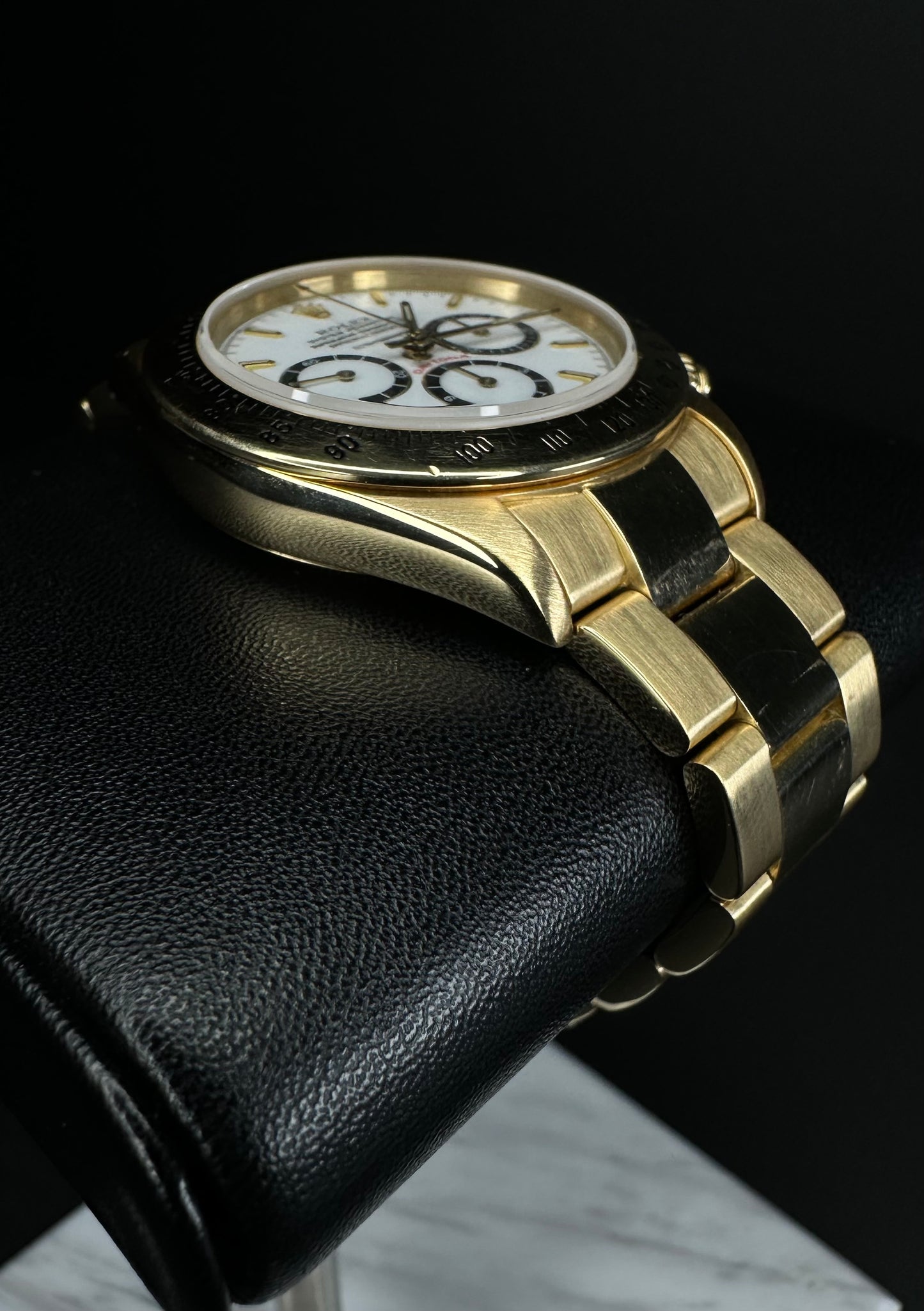 Rolex Cosmograph Daytona men’s automatic watch, model 16528, featuring a rare floating porcelain dial and crafted in 18k yellow gold, from 1987. This vintage 40mm timepiece combines iconic Daytona functionality with unique collectible appeal, ideal for discerning collectors of rare luxury watches. Available from The Watch Trader in Madison, Connecticut.