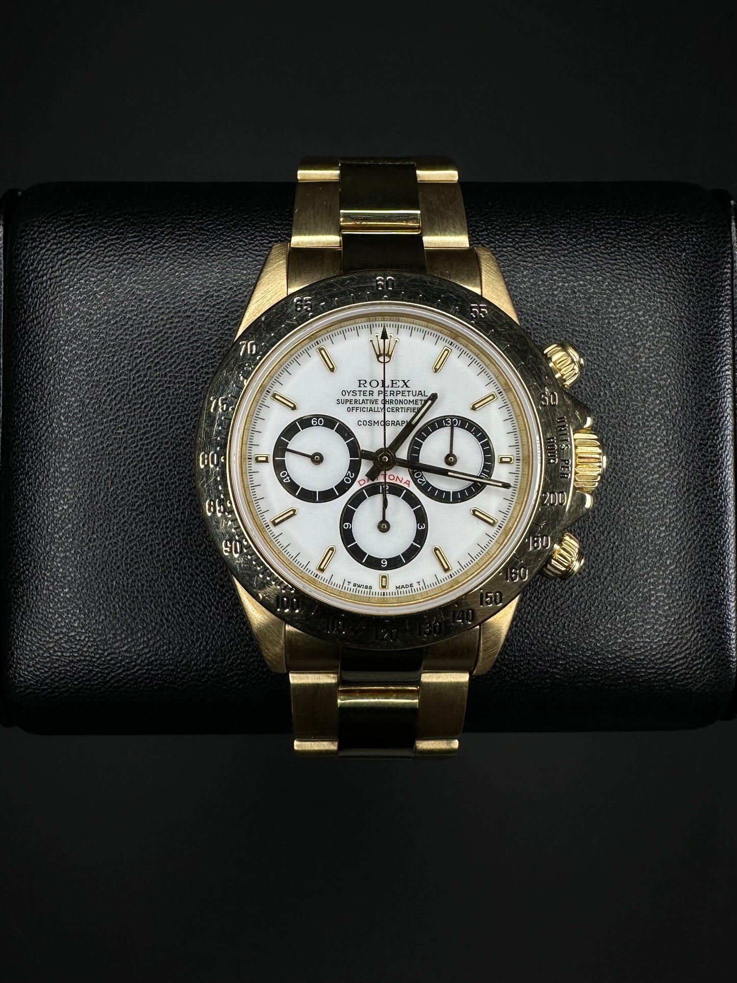 Rolex Cosmograph Daytona men’s automatic watch, model 16528, featuring a rare floating porcelain dial and crafted in 18k yellow gold, from 1987. This vintage 40mm timepiece combines iconic Daytona functionality with unique collectible appeal, ideal for discerning collectors of rare luxury watches. Available from The Watch Trader in Madison, Connecticut.